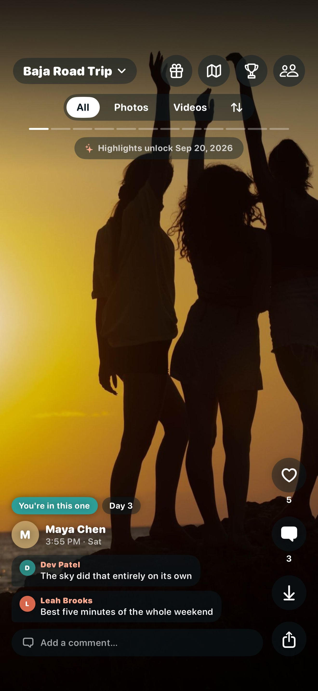 Unframed reveal feed for "Baja Road Trip": a full-screen photo of friends silhouetted at sunset, with likes, comments and a "You're in this one" tag.